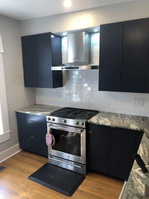 paint cabinets and install new backsplash, clean lookin!