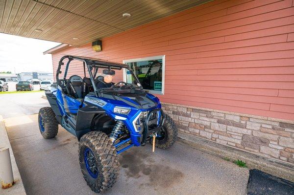 A customer drives their ATV to out drive-thru window.