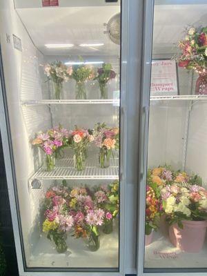 Cooler with an assortment of Joy Jars and premade bouquets.