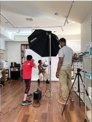 Visiting artist teaching students how to use a lighting setup