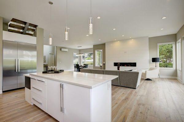 Beautiful modern designed kitchen with modern lighting, painted walls and hardwood floor.