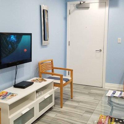 Lobby, with kid friendly movies on the TV.