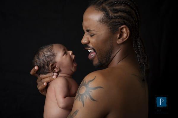 atlanta newborn portrait session with father holding newborn son