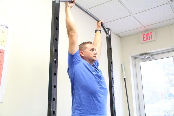 Donald working one on one with one of our performance therapists on his shoulder position for pain free pull ups during his work outs.