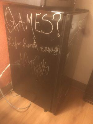 Graffiti on the refrigerator in our room.