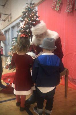 My toddler and her friend Falcon I nanny finding the bell in the story! POMS Winter Social the mother of the kid's I nanny invited us to!