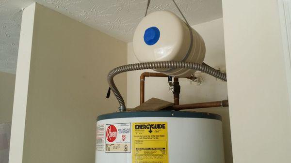 Plumbit services installation of replacement expansion tank with  hanger for safety and code