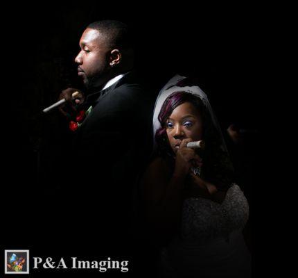 The image is of a bride and groom standing back to back