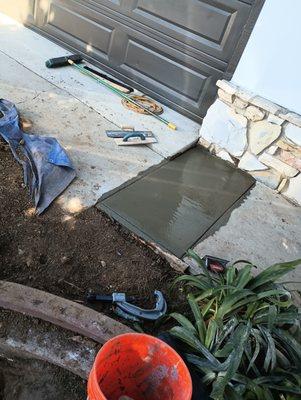 New concrete patch where pipe was installed