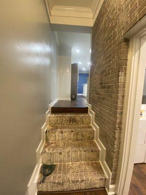 Foyer brick wall brick steps previously painted, stripped for the original vintage look, looking great!!