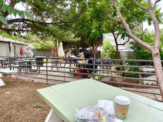 Handheld breakfast sandwich & coffee on the patio.