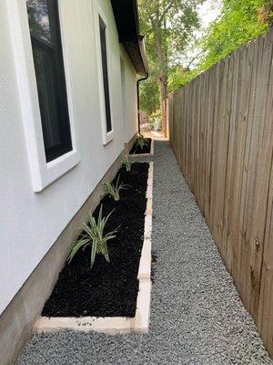 Fence and black start gravel pathway