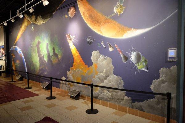 Find space phenomena from pop culture hidden in the "Time & Space" mural--created by world-famous space artist Michael Carroll.