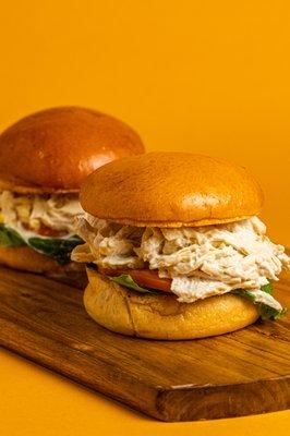 The classic chicken salad sandwich. Perfectly toasted brioche bun, romaine lettuce, tomato slices, shredded chicken tossed