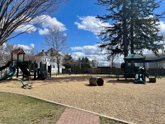 Different options for climbing and sliding. In the far background, there's a swingset for different ages.