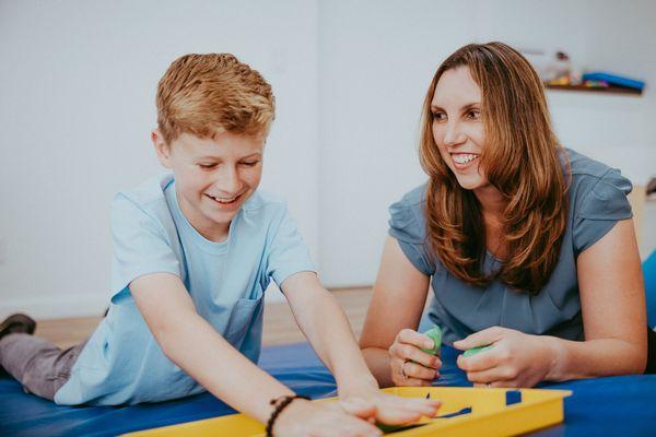 Miss Christina using Theraputty to support hand strength