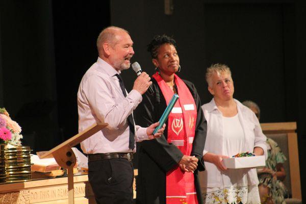 Pastor David passes the baton to Pastor Sharon.