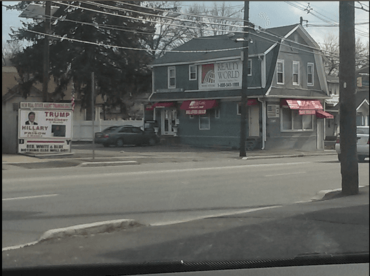 One of three ginormous pro Trump signs on the Realty World property.