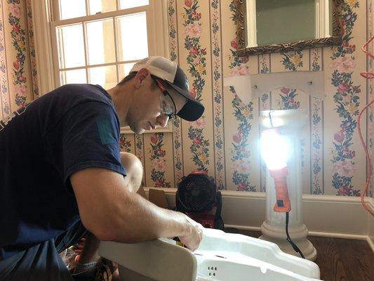 Here's Bobby installing a new faucet and drain assembly on a pedestal sink!