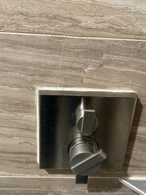 Cracked wall title around shower control