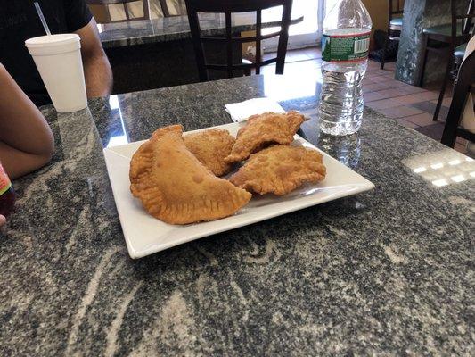 Freshly prepared cheese empanadas, fried to a golden brown. Has yellow cheese inside. (7/2/2018)