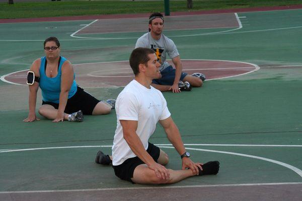 Helping a group of marathon runners do pre race stretching