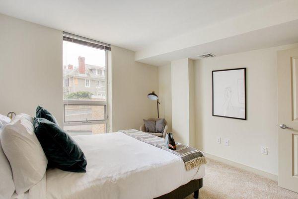 Bedroom 13 with floor to ceiling window, bed and night stands