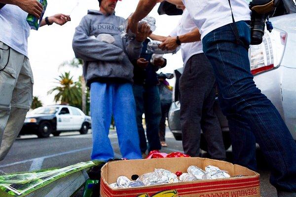 Distributing burritos to the Civic Center's homeless