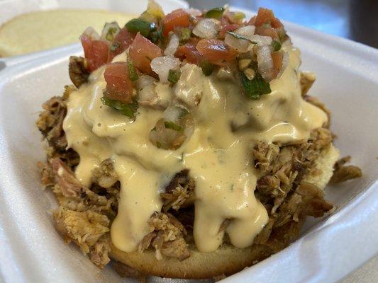 Chopped chicken sandwich with queso and pico.