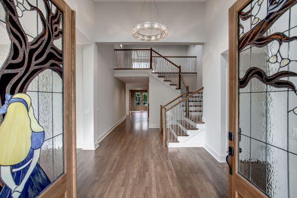 Alice in Wonderland themed leaded glass entryway doors in partnership with Nip Tuck Remodeling