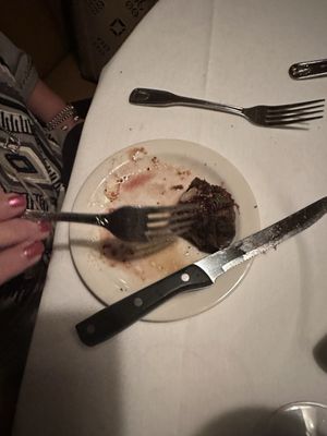 The steak had to be eaten from a salad plate because the waiter forgot to bring a plate.