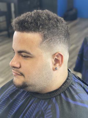 Semi-Low skin drop fade  , Kept enough on top to preserve the curls.