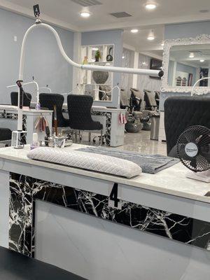 Nail tech table and in the distance is the Pedi Spa area