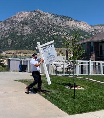 Here is Jonah installing a sign on his first luxury listing!