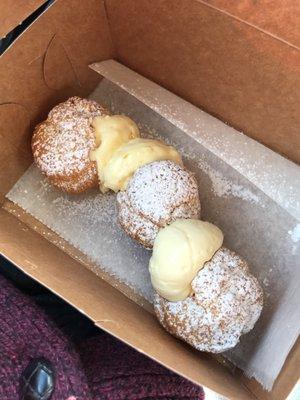 Fresh cream puffs filled the moment you order them. Two kissing coconuts and a lonely vanilla .