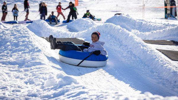 Enjoy the crisp alpine air on a snow tube at Grizzly Ridge Tube Park.