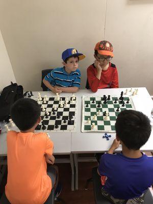 Young chess Ninjas playing after hours of solving puzzles and lectures.