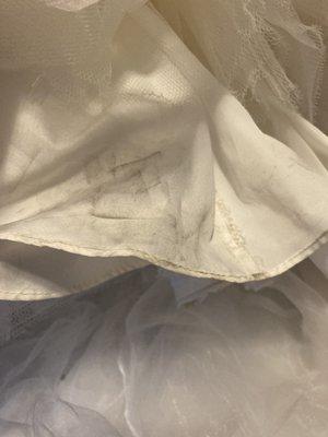 Dirt stains on wedding dress remaining after it was cleaned, 8/31/21