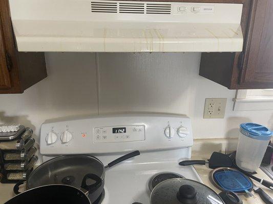 Brown residue landing on the stove and in the food.