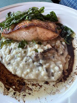 Salmon topped with crispy fried spinach and brown butter sauce, served with mushroom risotto