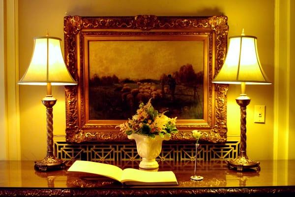 Guest book and floral arrangement.