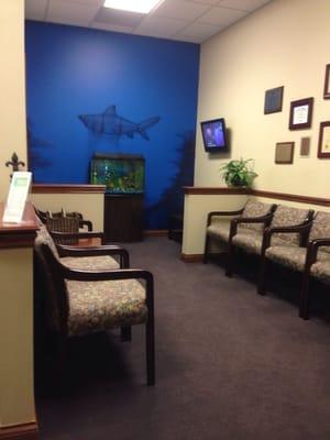 Waiting & kids area w/ aquarium and cartoons.