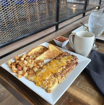 The Big Texas Omelet is stuffed with chopped Brisket, grilled onions, grilled green bell peppers, & homemade cheese sauce.