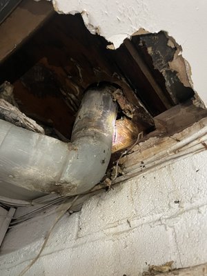 Deteriorated toilet flange causing leak and rocking bowl