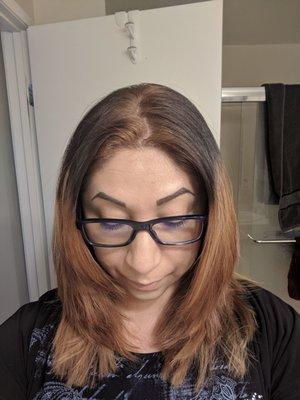 Brown roots, black in the middle, uneven (hardly) blonde tips. Hacked layers.