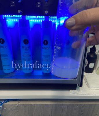 Our professional Hydrafacial machine and us holding some gunk water from a cleansing.