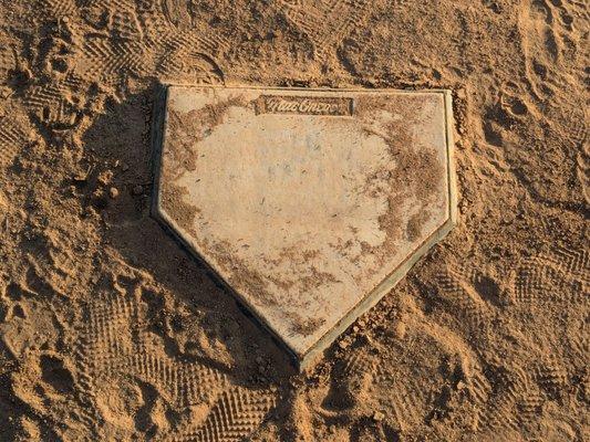 Home plate in front of the backstop