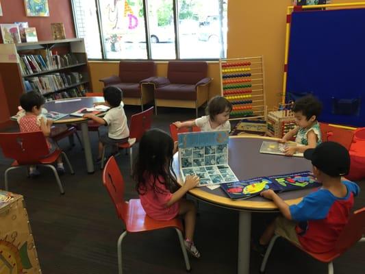 Learn and Grow kids reading their books at the library children's corner