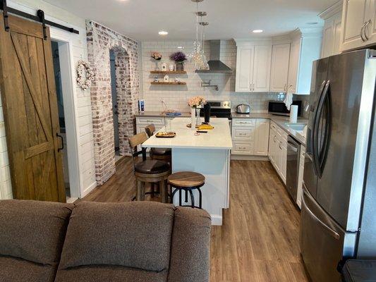 Downstairs in the 2 bedroom house- kitchen and bathroom (with shower stall) on the left