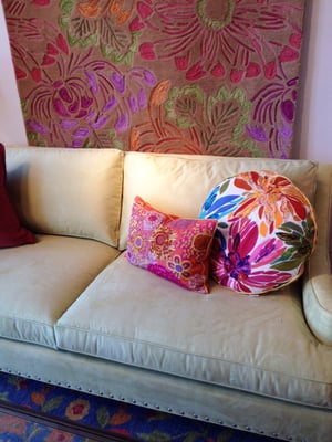 Bold and vibrantly patterned pillows, fine furniture and rugs